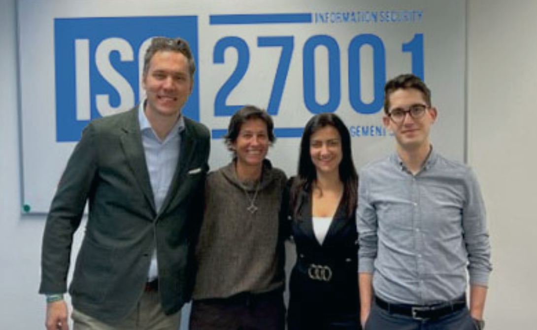 CONVOTIS team in front of an ISO 27001 certification sign – information security and compliance