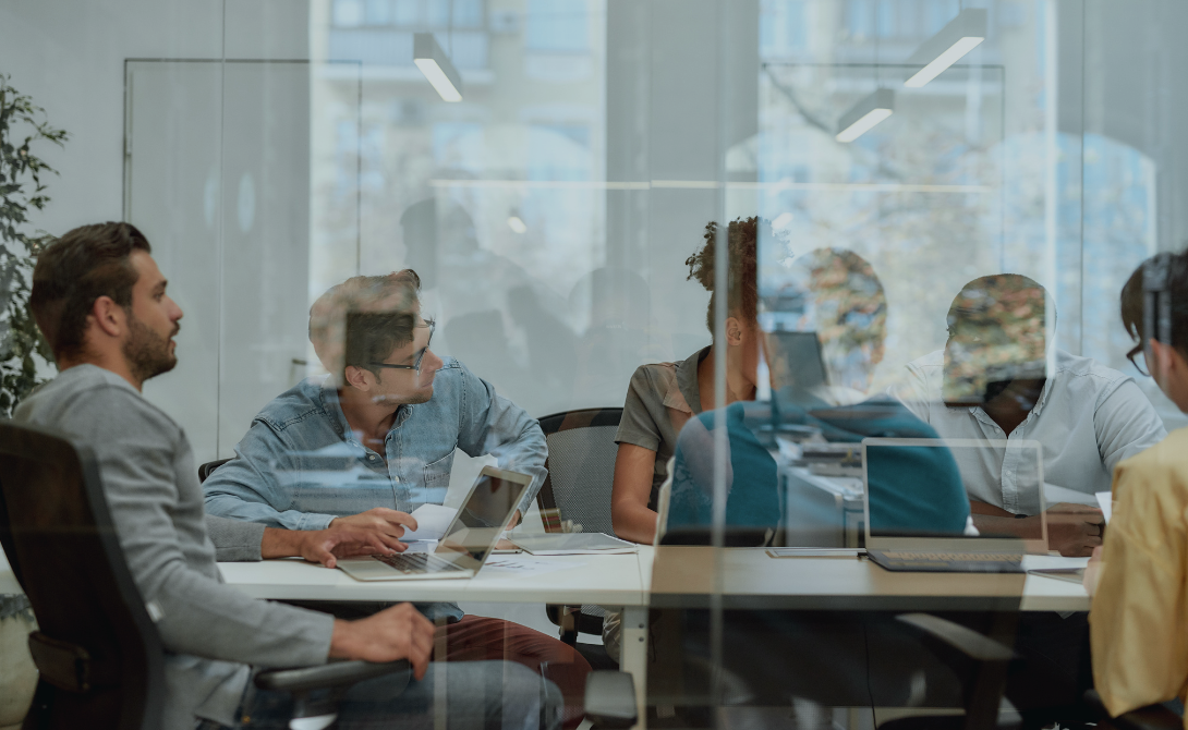 Business team in a meeting room discussing ERP solutions – optimizing processes with CONVOTIS