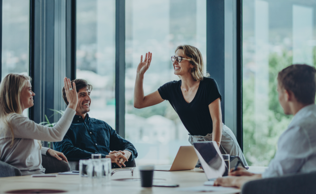 Business meeting with four people collaborating in a modern office – CONVOTIS ranks 19th on the Lünendonk list