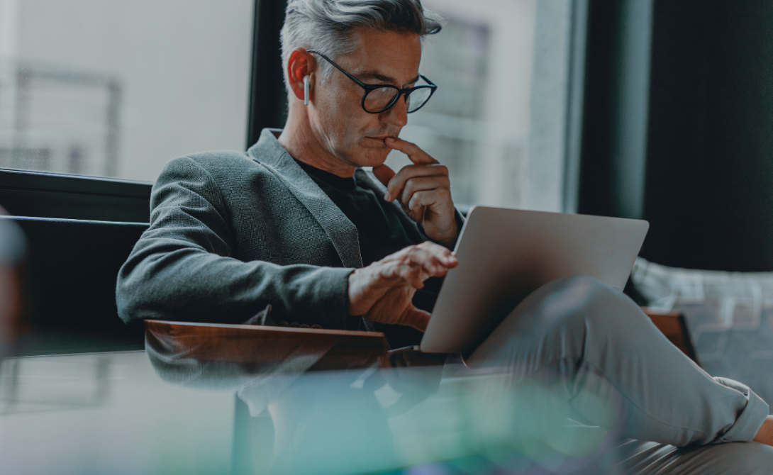 Business professional using a laptop in a public space – highlighting the need for robust endpoint security in modern IT environments