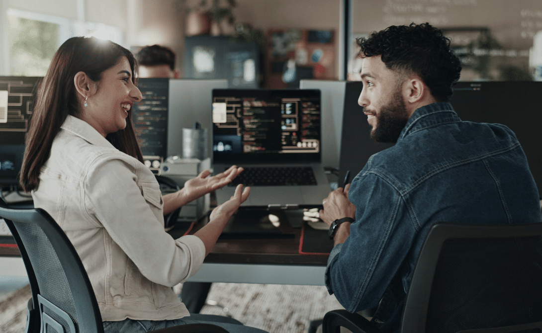 Developers collaborating in a cloud development environment with CI/CD pipelines and source code editors on screen – modern DevOps in action.
