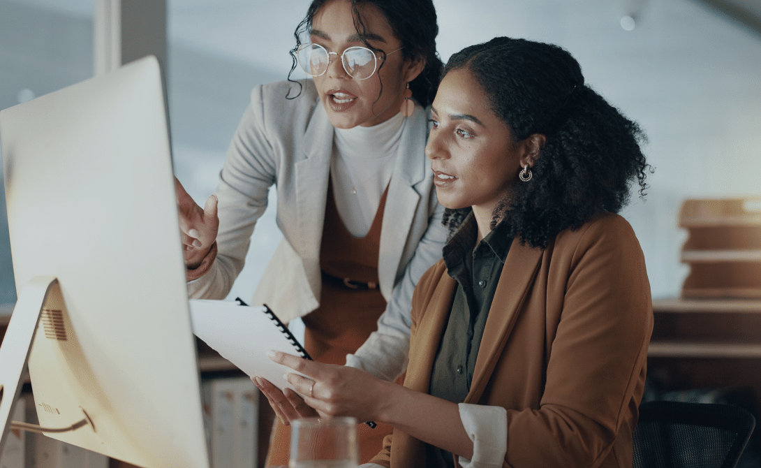 Two professionals collaborating on digital document & archiving workflows - optimizing document management and compliance processes