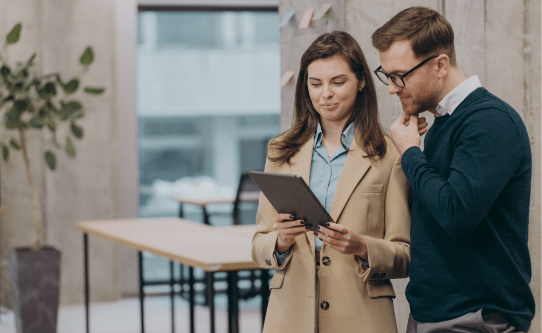 Two professionals reviewing enterprise documents on a tablet – illustrating integrated document workflows and SAP-connected Enterprise Content Management (ECM) with OpenText xECM.