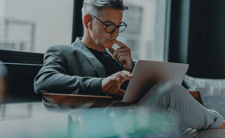 Business professional using a laptop in a public space – highlighting the need for robust endpoint security in modern IT environments