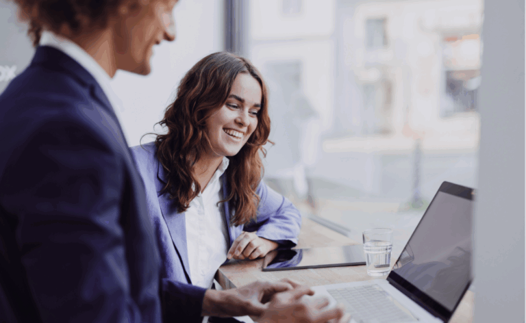 Business professionals analyzing AI-driven insights on a laptop – showcasing real-world collaboration with Data Science & AI for smarter decisions.