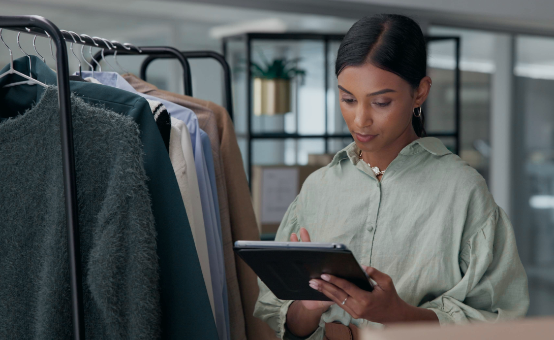 Woman managing e-commerce operations with a tablet in a fashion warehouse – digital platform for retail
