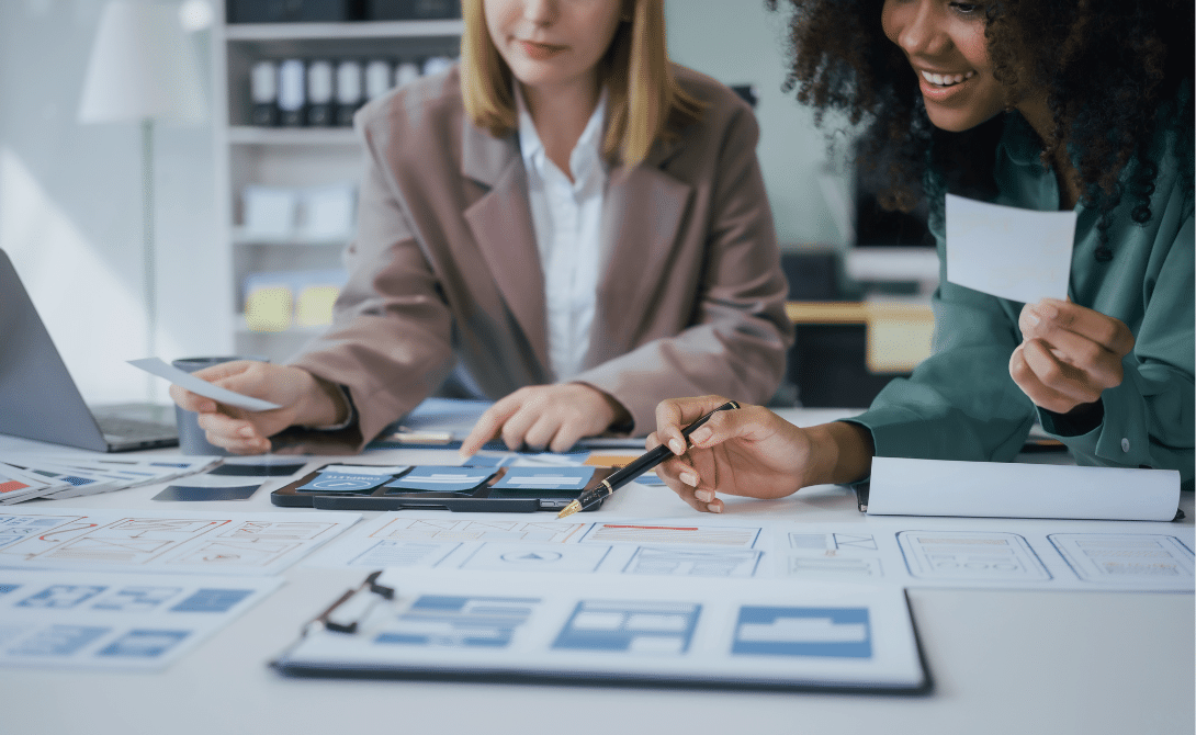 Two professionals collaborating on user journey mapping and interface planning – representing Total Experience Solutions, omnichannel strategy, and integrated CX/EX/UX platforms.