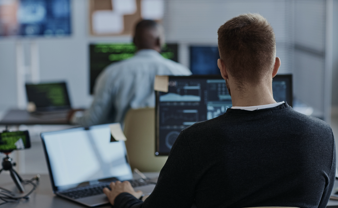 IT specialist working on Kubernetes security configurations at a workstation.